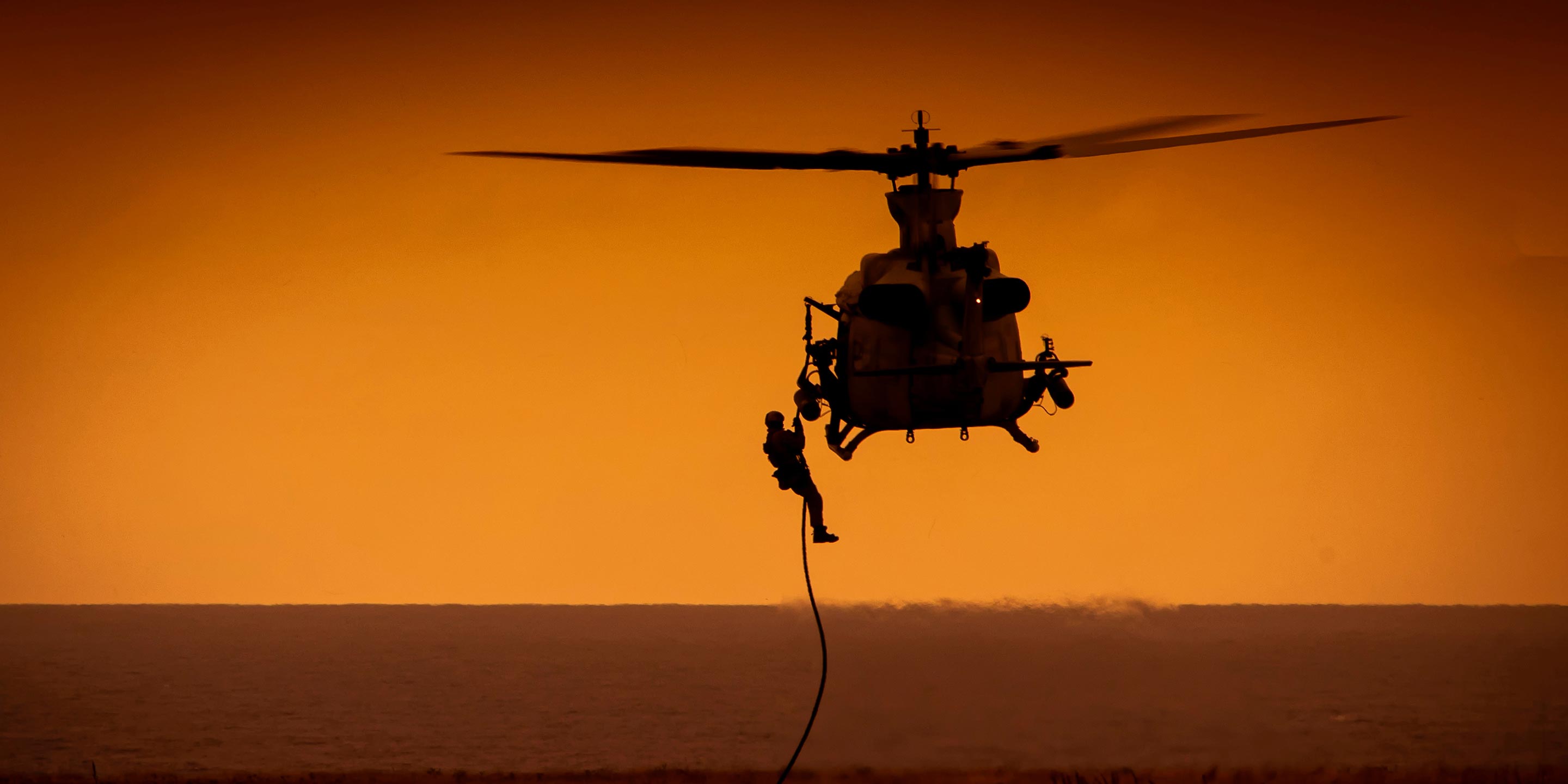 Soldier flying in a Chinook helicopter mid-air
