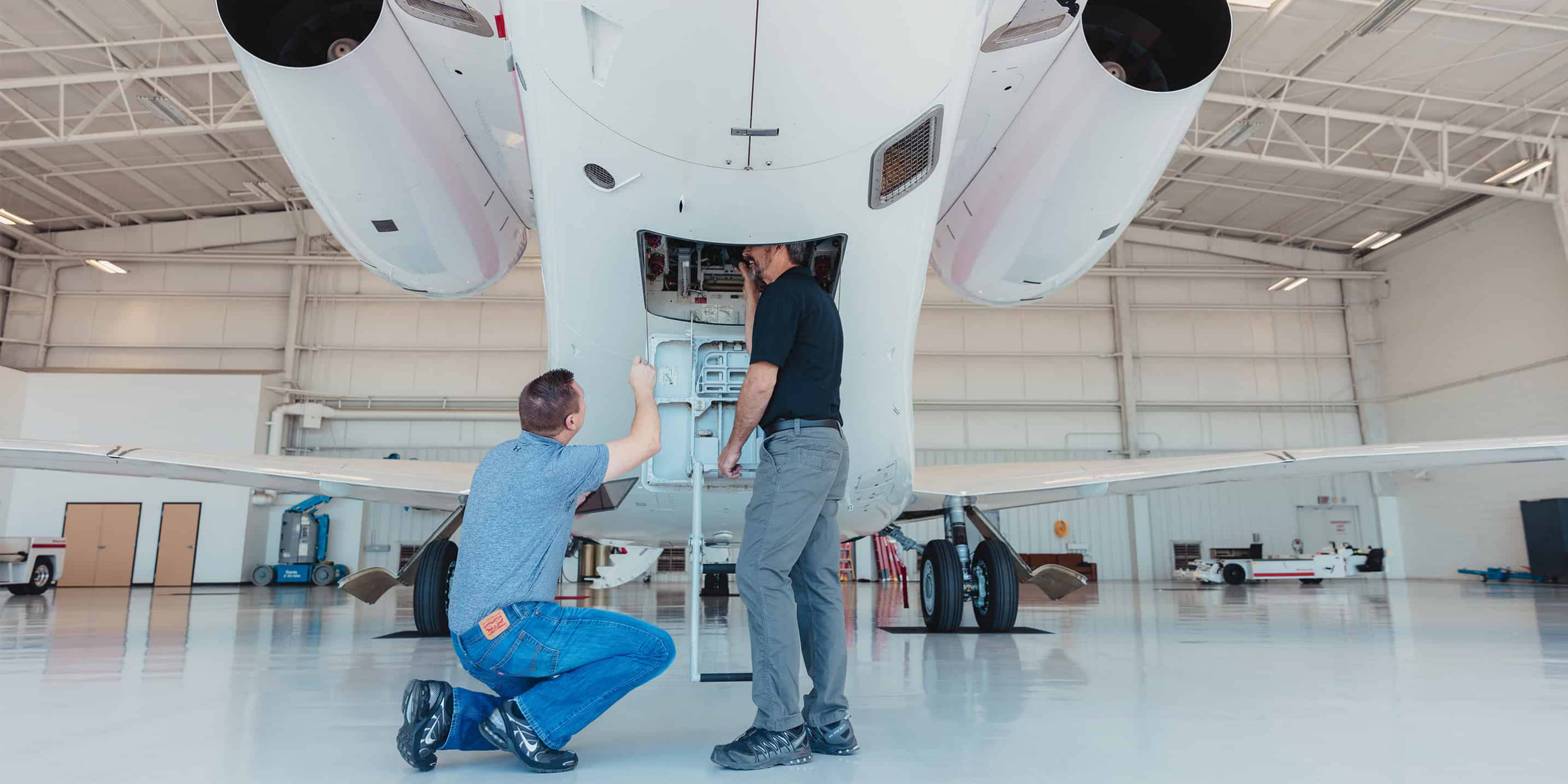 Two engineers performing aircraft maintenance